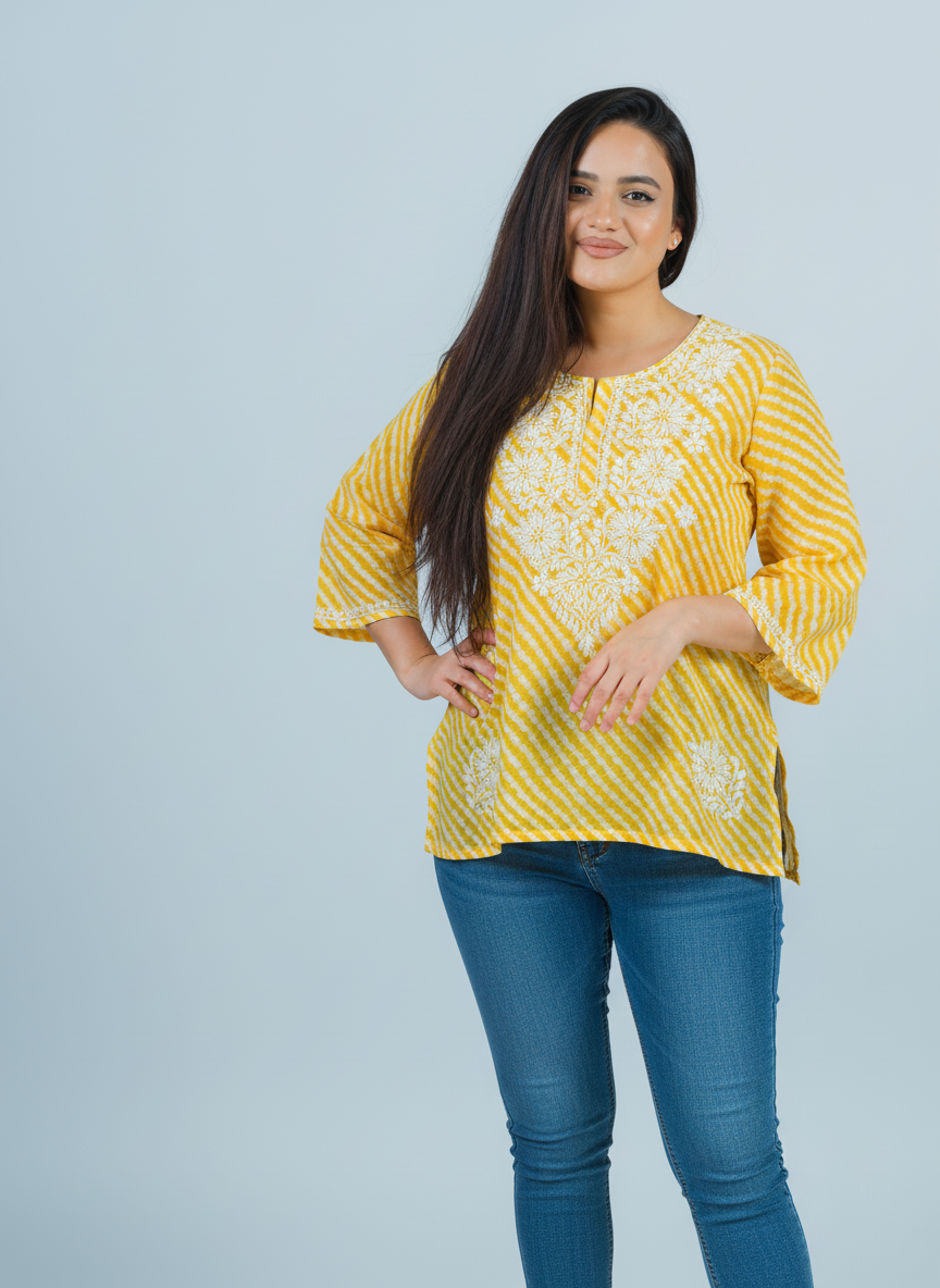 Model wearing a Yellow Chikankari Kurti with intricate embroidery on soft Mulmul fabric.